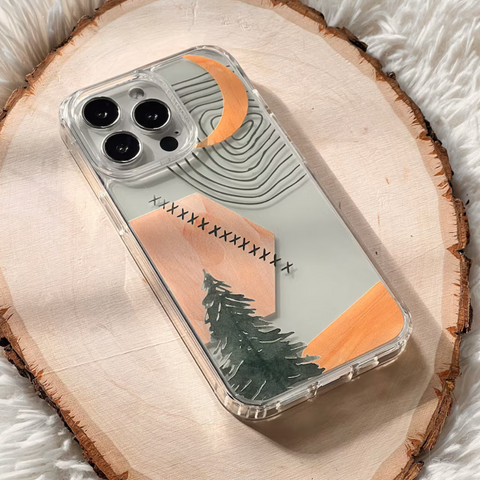 A clear phone case with a minimalist landscape design, featuring a crescent moon, geometric shapes, a pine tree, resting on a rustic wood slice over a white faux fur surface. (Feat)