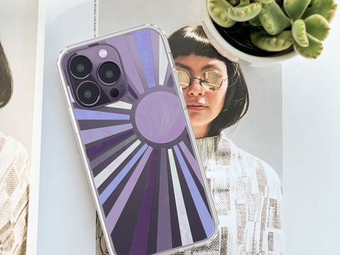 Deep purple iPhone 14 Pro Max clear phone case with The Urban Flair sun rays design