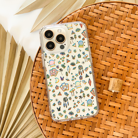 Phone case with a pattern of various mystic doodles. The pattern includes stars, mushrooms, crystals, and even sea shells. Feat